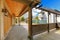 Garage and back porch with driveway. New luxury home exterior.