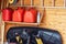 Garage corner with three red plastic fuel cans , staircase and snow plough for atv with wooden wall on background. Petrol gas