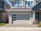 Garage door with driveway. Big modern custom house front yard and driveway to garage on a sunny summer day