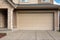 Garage Door. Modern house with garage door that is closed. A perfect neighbourhood. Family house with wide garage door