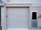 Garage with door residence on white brick