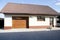 Garage garden house. Sliding gates. Hot sunny day.