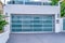 Garage with glass door under balcony with glass railing in San Diego California