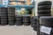 a garage, many new tyres are stacked so that they can be fitted as winter tyres