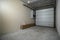 Garage in a newly built residential building. Garage lift door. Video surveillance system. Sectional lift gates