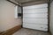 Garage in a newly built residential building. Garage lift door. Video surveillance system. Sectional lift gates