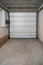Garage in a newly built residential building. Garage lift door. Video surveillance system. Sectional lift gates