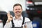 Garage service worker show ok sign with hand and happily smiling in uniform