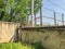 Garage Stone wall against the iron mesh, fencing and sky. Close up shot