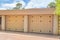 Garage with two textured yellow doors and drainage at La Jolla, San Diego, California