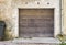 Garage wooden door, dirty cracked wall background