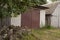 Garages for cars and green trees. Suburb. Summer