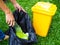Garbage collection in black bags, With yellow trash placed in garden. Cleanup and Take care of environment and preserve