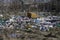 Garbage and construction debris scattered all around an empty lot in Bucharest, near a makeshift shelter