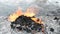 Garbage and fire burn in landfill