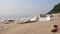 Garbage foam containers falling down on sand, polluted beach.