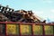 Garbage removal. Pile of wooden pallet waste on background blue sky