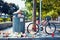 Garbage spilling out from a garbage bin or trash can on the street with a bicycle parked next to it in Montreal