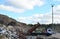 Garbage truck unloads construction waste from container at the landfill. Industrial waste treatment processing plant. Recycling