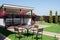 Garden Or Backyard Outdoor Pavilion With Wood Pergola, Bar Counter, Brick Oven, Fireplace And Barbecue For Cookout Food. Summer