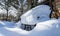 Garden bench covered with white fluffy snow after night snowfall. Calm picture of winter snow-covered garden.