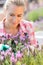 Garden center woman with purple plant flower