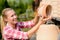 Garden center woman putting clay pots shelf