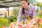 Garden center woman working in pink flowerbed