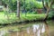 Garden chairs and garden table directly at a little creek and floating river, birch trees and idyllic scene are the perfect travel