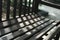 Garden dark brwon wooden bench with day light and shadow