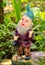 Garden dwarf figurine - dwarf holding a lamp statuette in the garden