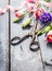 Garden Flowers with scissors, pink ribbon on old blue table