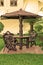 Garden furniture. chairs and table under wooden umbrella at garden