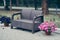 Garden furniture, plastic, wicker. A bench made of woven plastic. Lightweight portable garden furniture, next to a