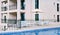 Garden furniture - sofas, armchairs and tables under an umbrella, near the pool.