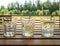 Garden furniture on the terrace of a country house, hotel. Three glasses with a refreshing drink with lemon on a wooden table. One