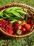 Garden gifts. Strawberries, green peas and redcurrants in woden baskets on ground