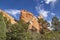 Garden of the Gods in Colorado Springs - huge red rock bluffs jut upwards against dramatic blue sky with whispy clouds