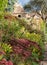 Garden at Great Chalfield Manor near Bradford on Avon, Wiltshire UK, photographed in autumn with red sedum flowers in foreground.