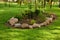 The garden island on the lawn was covered with large boulders and ornamental plants were planted inside it.