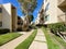 Garden and lawn along the walk path through the typical condo complex building.