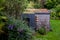 Garden office with black and cedar cladding and green living sedum roof.