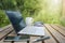 Garden office with laptop, smart phone, glasses and coffee on a wooden table in the backyard, stay home during corona crisis, copy