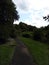 Garden path with wood bench before a rain storm