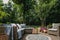 Garden patio decorated with Scandinavian wicker sofa and coffee table