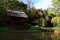 Garden pergola, pond with pillars, surrounded by cherry trees and willows in japanese pavilion