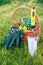 Garden pruner, hand trowel and gloves with wicker basket in green grass