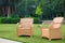 Garden rattan armchairs on green grass