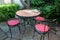 Garden restaurant - three garden stools and a garden table with menu at a garden restaurant