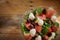 Garden salad with tomatoes, cucumbers, olives, fresh mozzarella and arugula